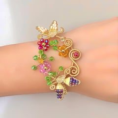 GENERICO - PULSERA MARIPOSAS Y FLORES TEJIDA