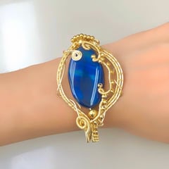 GENERICO - PULSERA BRAZALETE TEJIDA DORADA CON PIEDRA AZUL